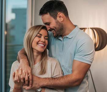 Attractive young couple in love hugging.